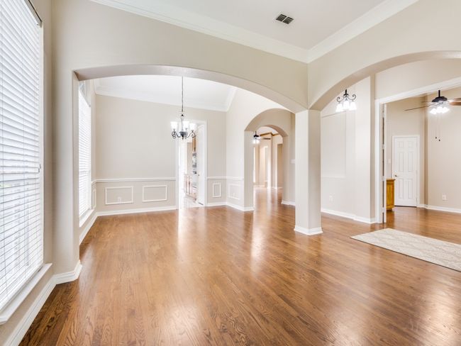 Stacked formals. This view is from the formal living area and looking towards the formal dining room and kitchen. The arched entries and crown molding are a nice upgrade. | Image 8