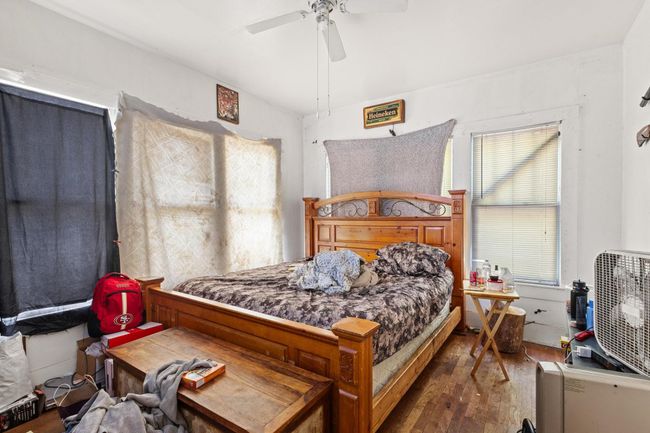 Bedroom featuring hardwood / wood-style flooring and ceiling fan | Image 12