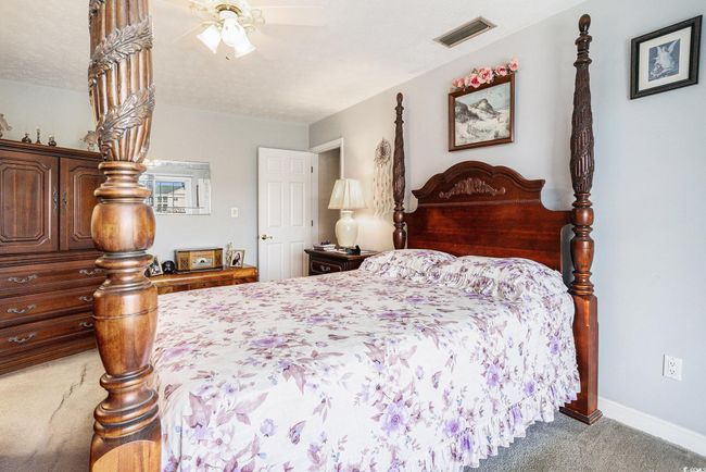 Bedroom with carpet flooring, baseboards, and a ceiling fan | Image 24