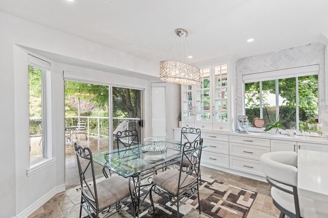 Dining area with stone tile flooring, a chandelier, baseboards, and recessed lighting | Image 15