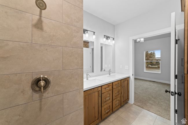 Bathroom with tile patterned floors, a sink, and double vanity | Image 33
