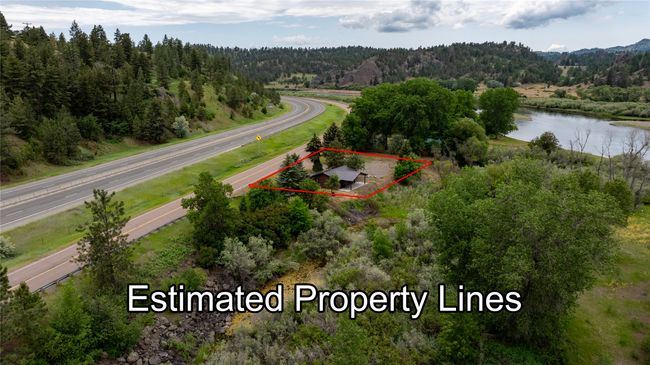 Aerial view of property and surrounding area with property boundaries highlighted and a nearby body of water | Image 50