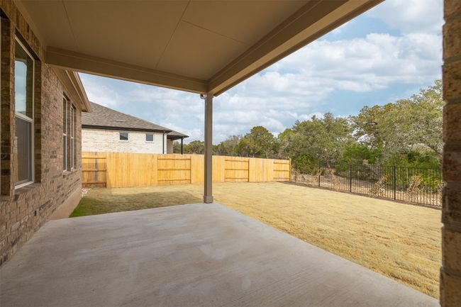 Fenced backyard with a covered patio area | Image 14